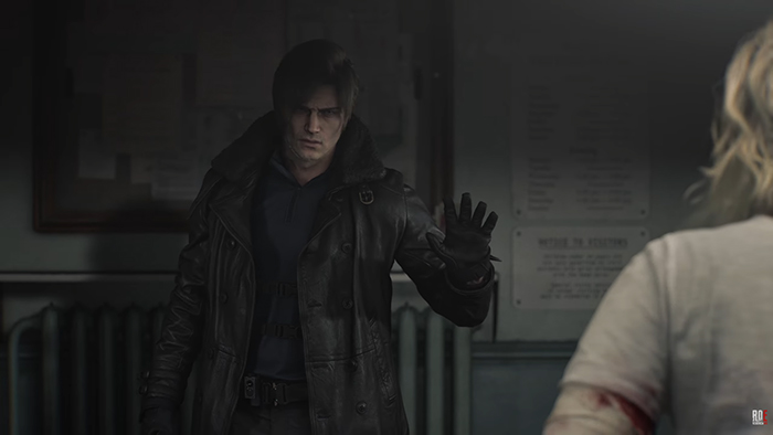 Leon Kennedy in Resident Evil: Requiem, facing Grace Ashcroft in a dimly lit hospital corridor. He raises his hand in a defensive gesture during their conversation, suggesting tension or an impending threat.