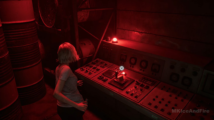 A female character with blonde hair stands in front of a large control panel illuminated by red emergency lights.