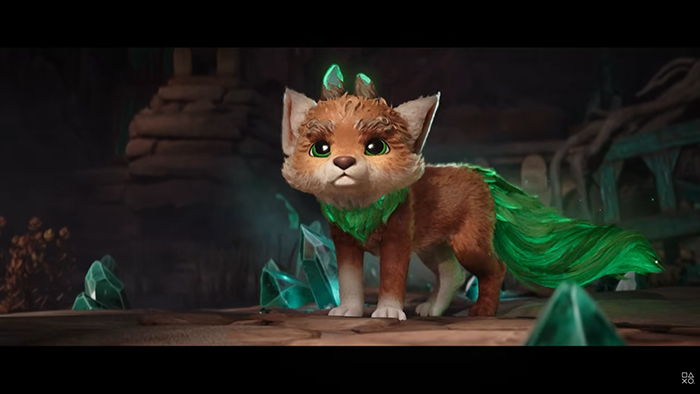 A small, fox-like spirit creature with glowing green eyes and a flowing emerald tail stands alert in a dark, ancient ruin. Crystals glow around it, suggesting magical energy.