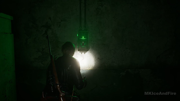 The character shines his flashlight on a hanging green electrical box containing a battery, preparing to remove it.