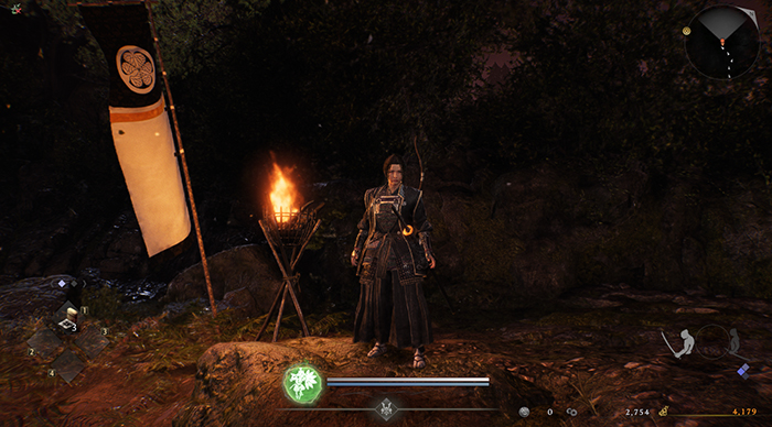 Nioh 3 character standing near a campfire with blue Guardian Spirit icon, indicating stealth or defensive stance.