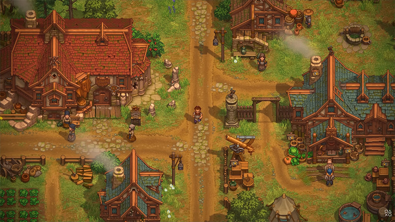 Top-down isometric view of a rebuilt medieval town in Graveyard Keeper II: cobblestone streets lined with timber-framed houses (red-tiled and green-slated roofs), workshops, gardens, and NPCs interacting. A central path leads past a cannon, well, and market stalls; smoke rises from chimneys, suggesting active daily life amid post-apocalyptic recovery.