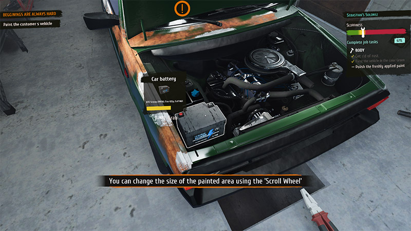 Close-up of an open car hood revealing a rusty engine bay; a new battery is being installed beside the old one.