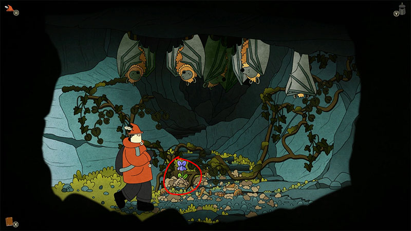 Inside a dim cave, several giant bat-like creatures hang upside down from the ceiling. The protagonist in an orange jacket stands on the left, facing a strange flower glowing blue on the ground. A red circle highlights the flower, suggesting it is an item to be noticed or collected.