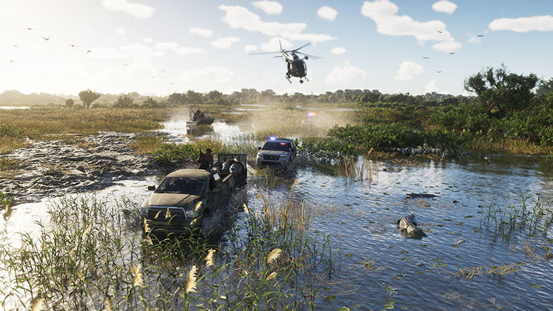 GTA6 official scene: A black pickup truck and a police SUV navigate through shallow swamp water with reeds and mud, while a military-style helicopter hovers overhead; an alligator swims nearby, and a small boat moves in the background under a partly cloudy sky.