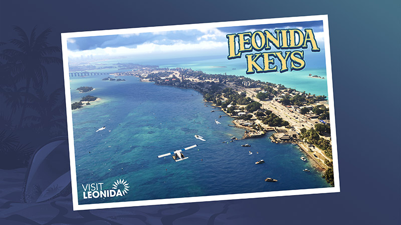 LEONIDA KEYS postcard: aerial view of a tropical island chain with turquoise waters, white-sand cays, palm-lined shores, scattered buildings, and a long bridge spanning the water; stylized “LEONIDA KEYS” text across the top.