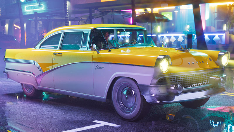 GTA6 official pre-order bonus scene: The Exclusive Nostalgic Ride — the 1955 Vapid Stanier classic dual-tone sedan — parked on a rain-slicked neon-lit street at night; headlights illuminate wet asphalt, reflections shimmer, and the driver is visible through the windshield.