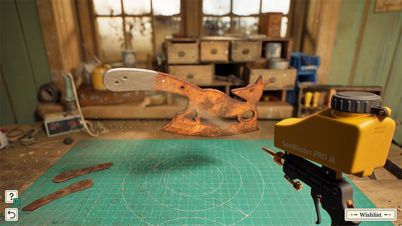 A rusty, fox-shaped meat cleaver hovers in mid-air as a yellow sandblaster sprays abrasive particles onto it, with two detached wooden handle pieces lying on the green cutting mat below.