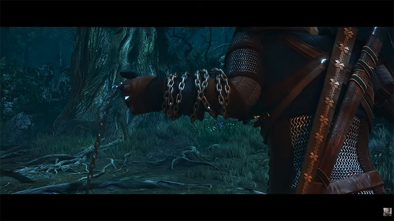 Geralt swinging a chain weapon in a dark forest, close-up of his chain-wrapped fist and armored arm.