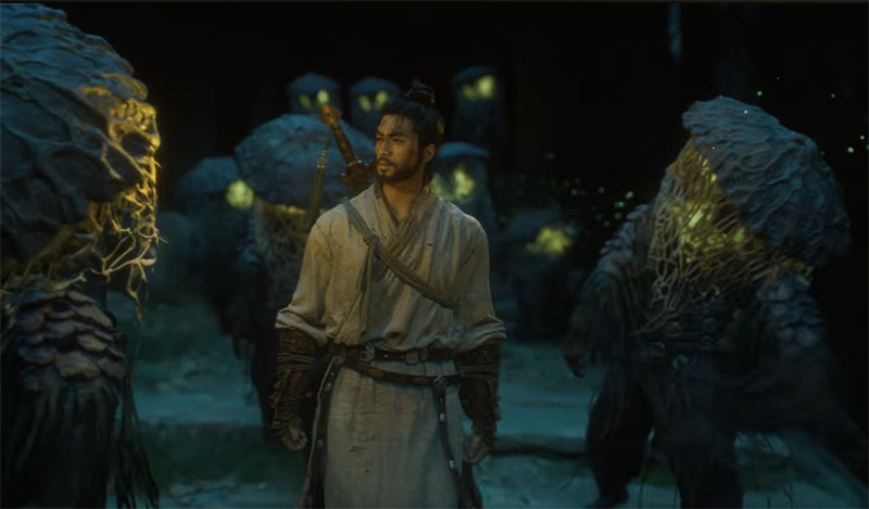 A robed swordsman walks between monsters in the dark.